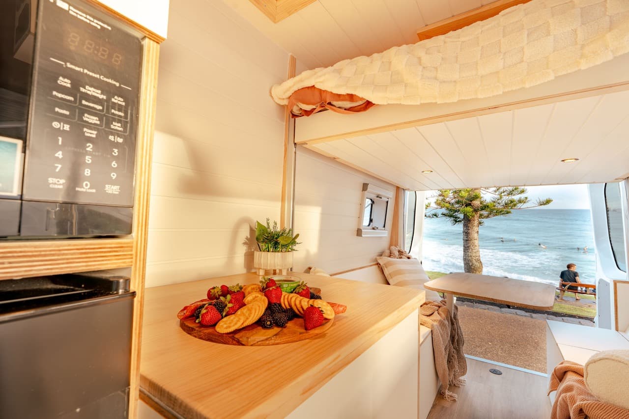 Fruit platter on the kitchen benchtop with the beach visible through the rear doors